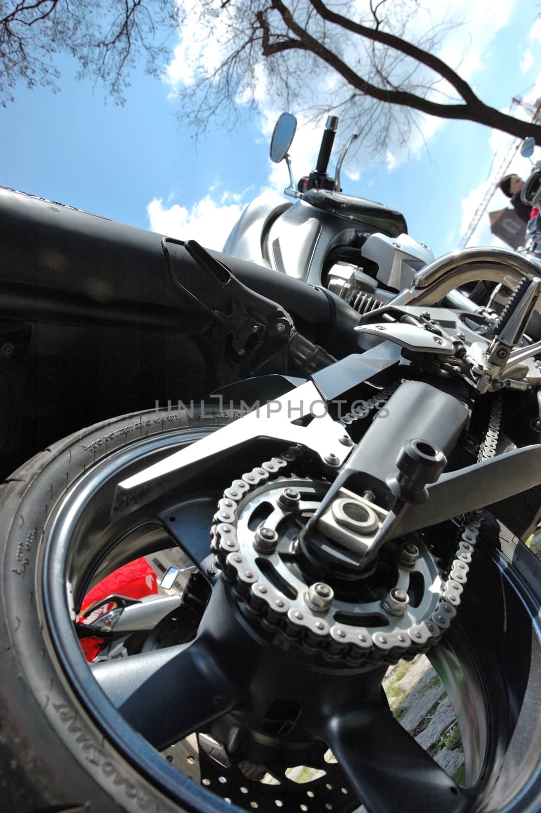 Photo of motorbike from behind with rim, tyre and chain.