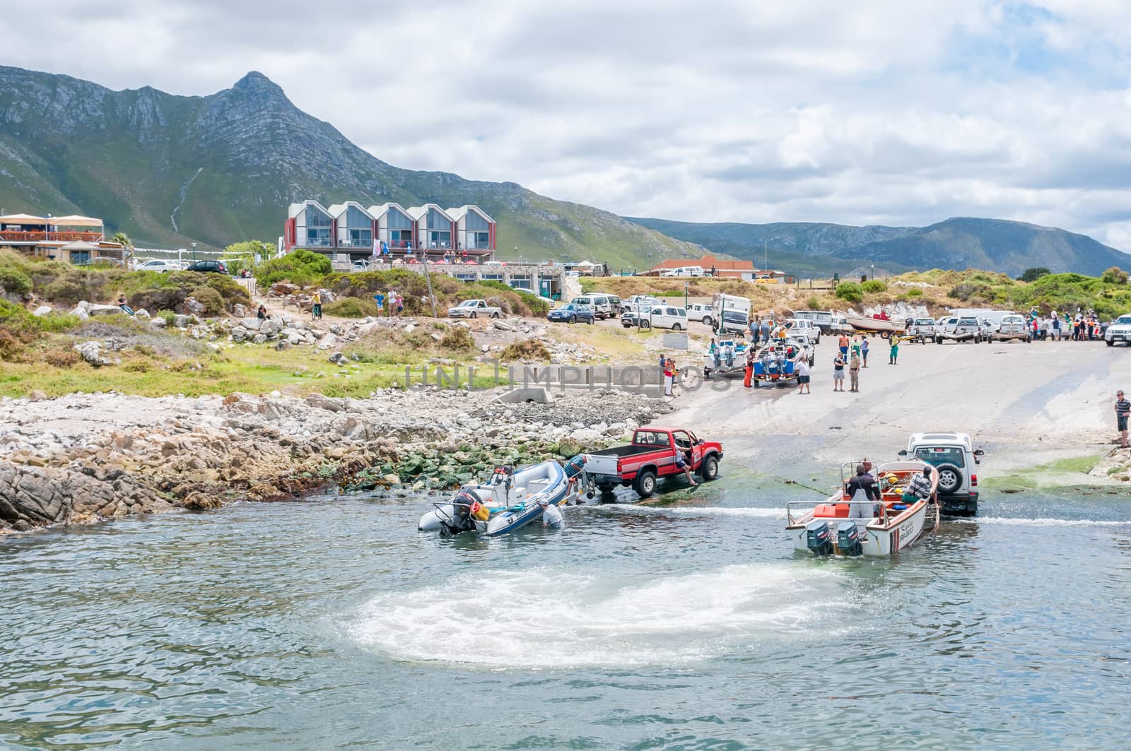 KLEINMOND, SOUTH AFRICA - DECEMBER 23, 2014: Crayfish boats being pulled with the days catch onto trailers at Kleinmond harbor
