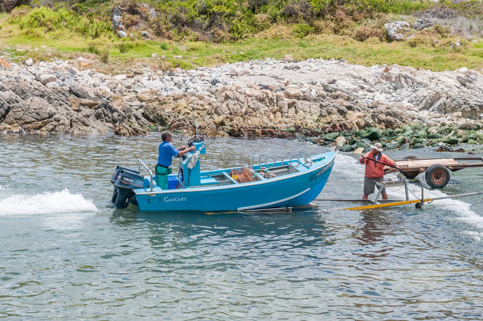 KLEINMOND, SOUTH AFRICA - DECEMBER 23, 2014: Crayfish boat being pulled with the days catch onto a trailer at Kleinmond harbor