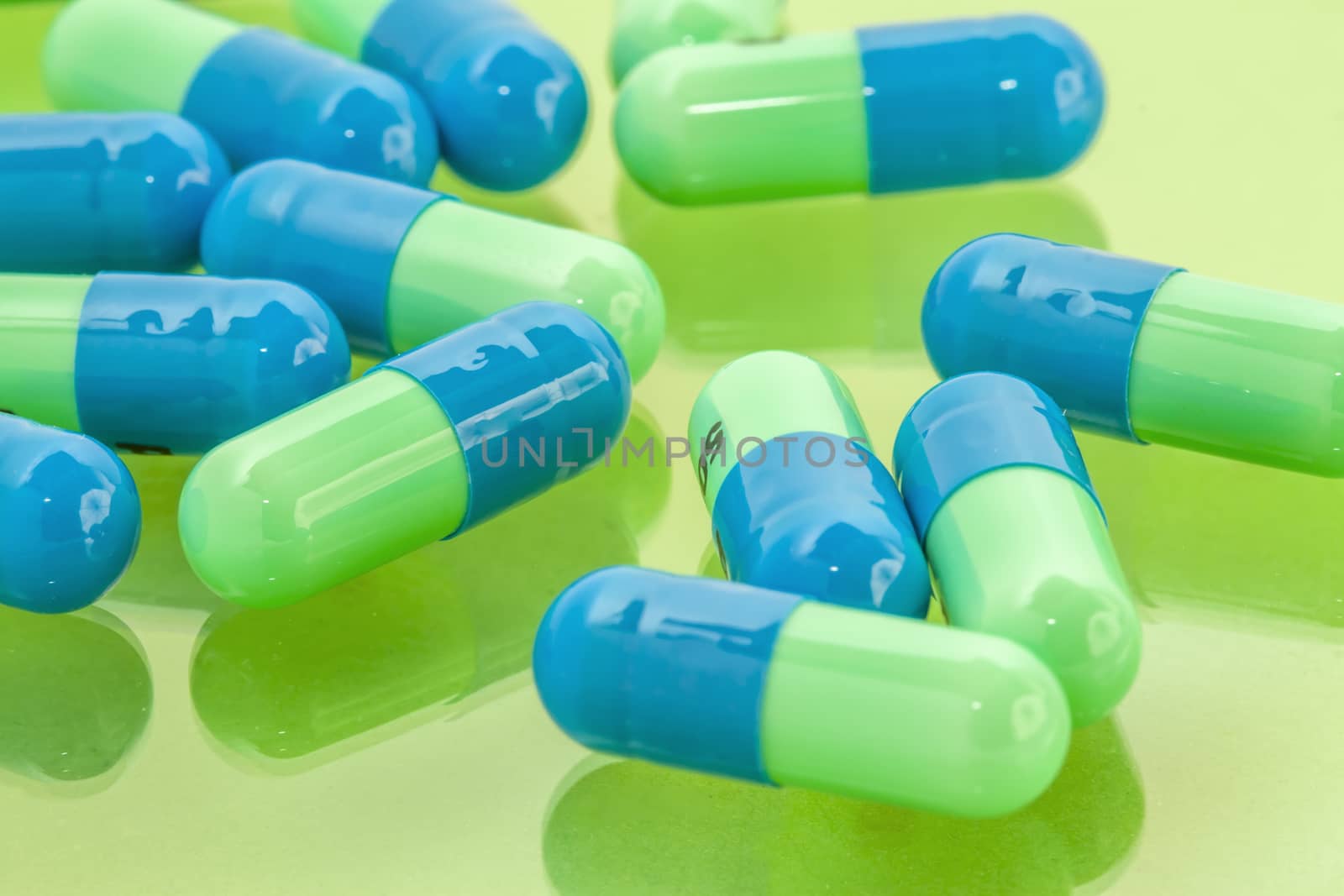 several blue-green pills spilling on the table