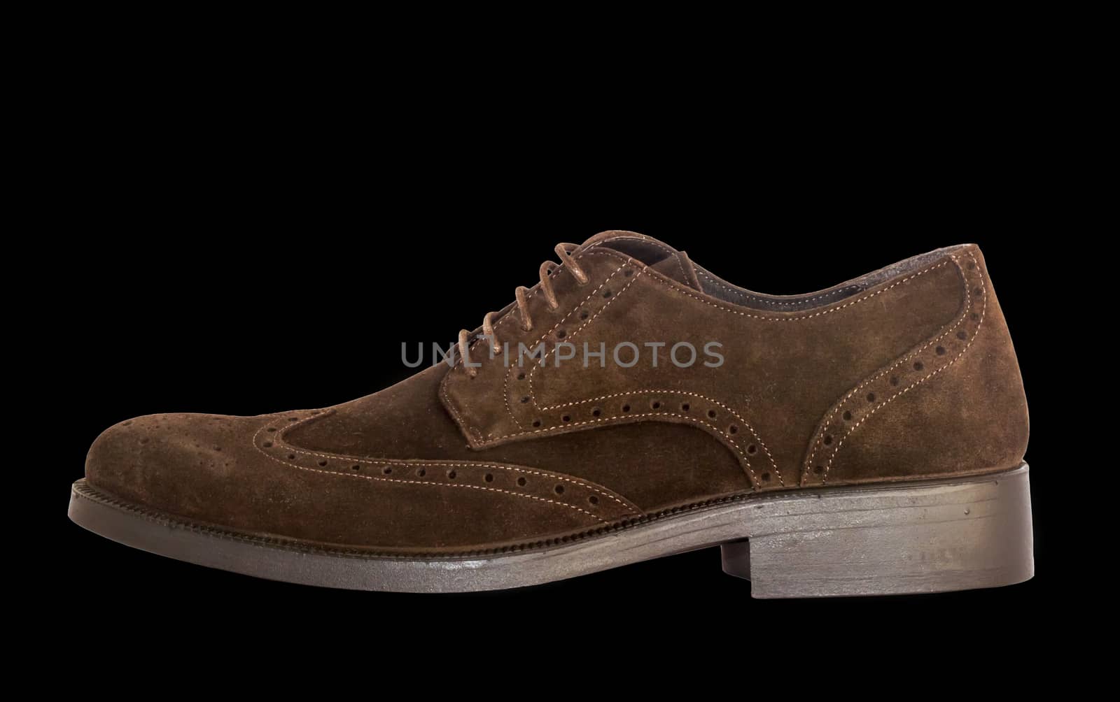 isolated brown suede shoes on the black background