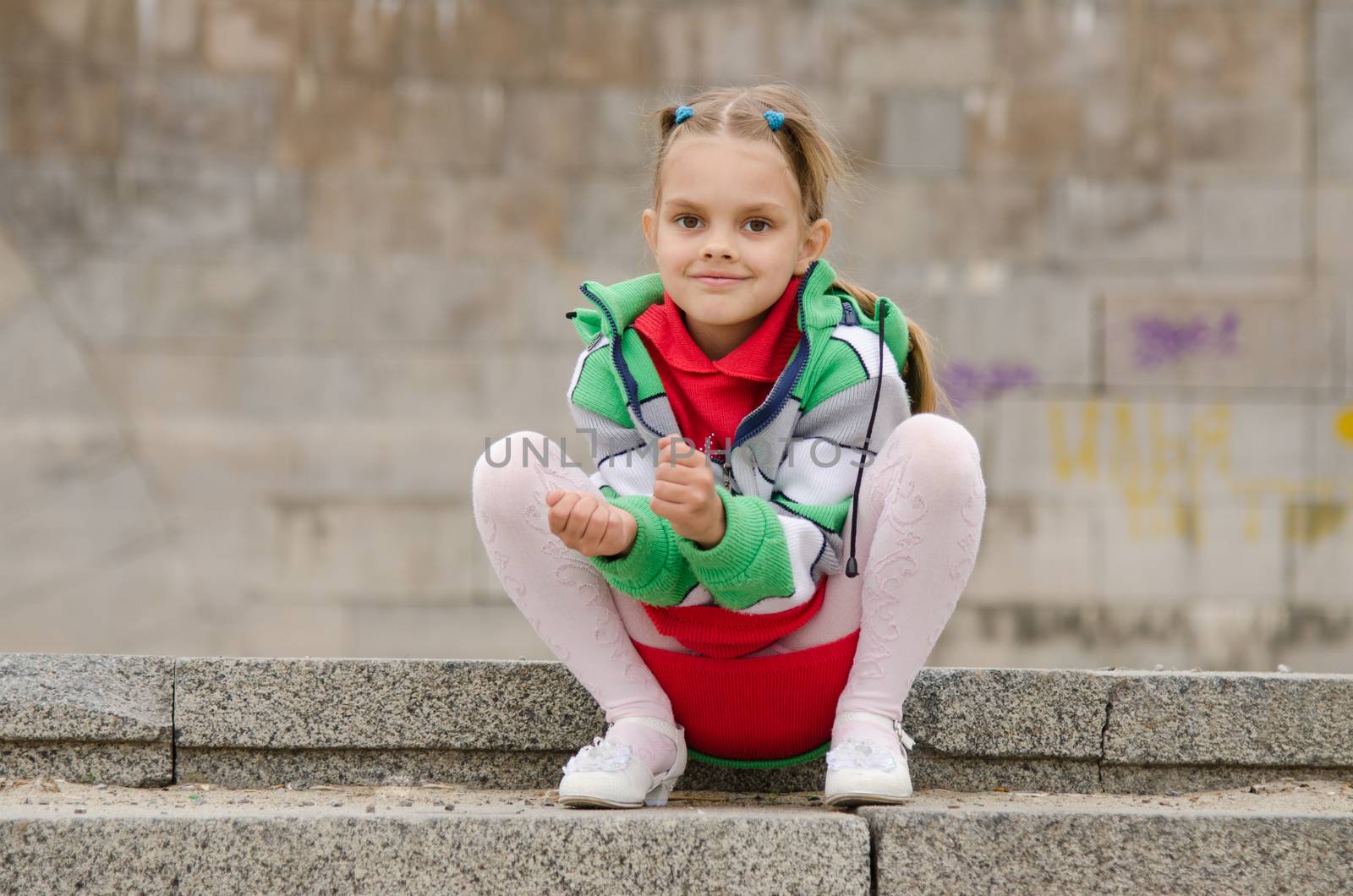 A girl of six years walking on the embankment