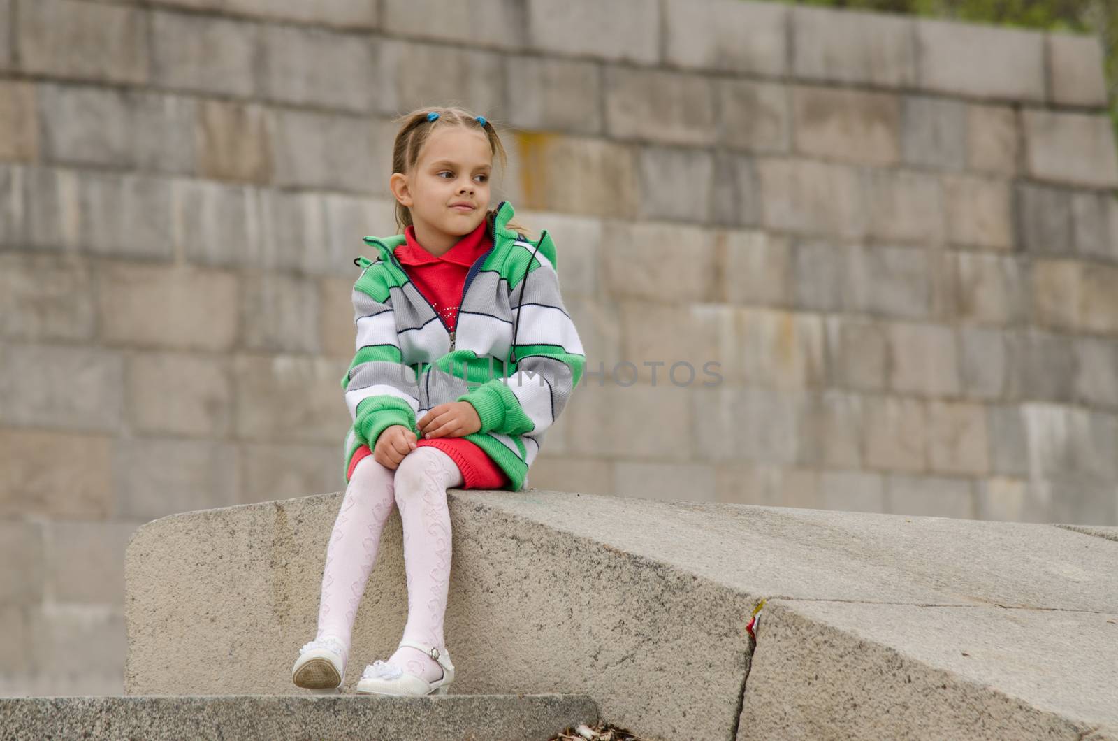 A girl of six years walking on the embankment