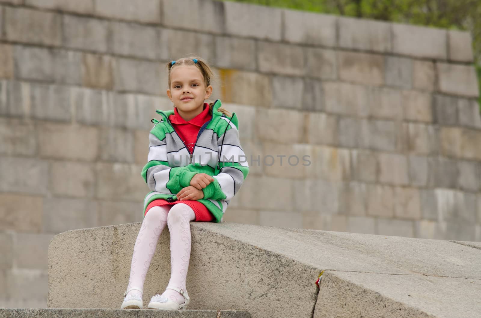 A girl of six years walking on the embankment