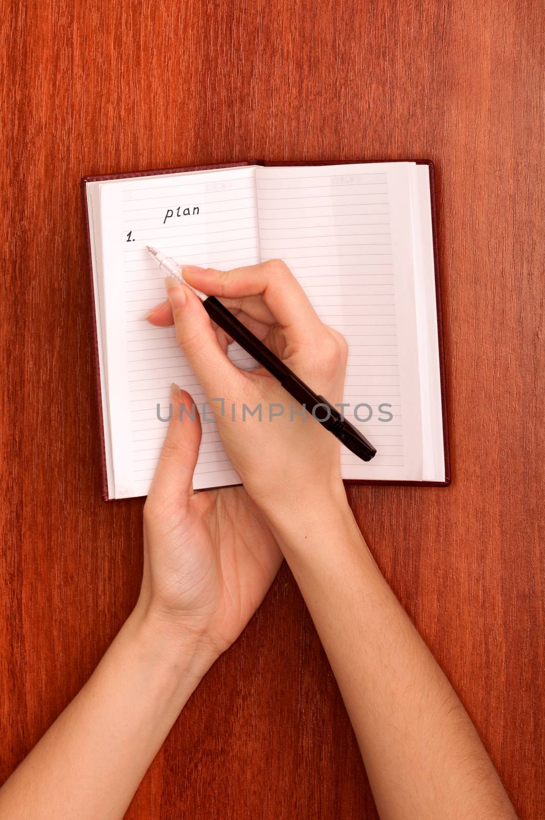 business woman writes notes for business plan