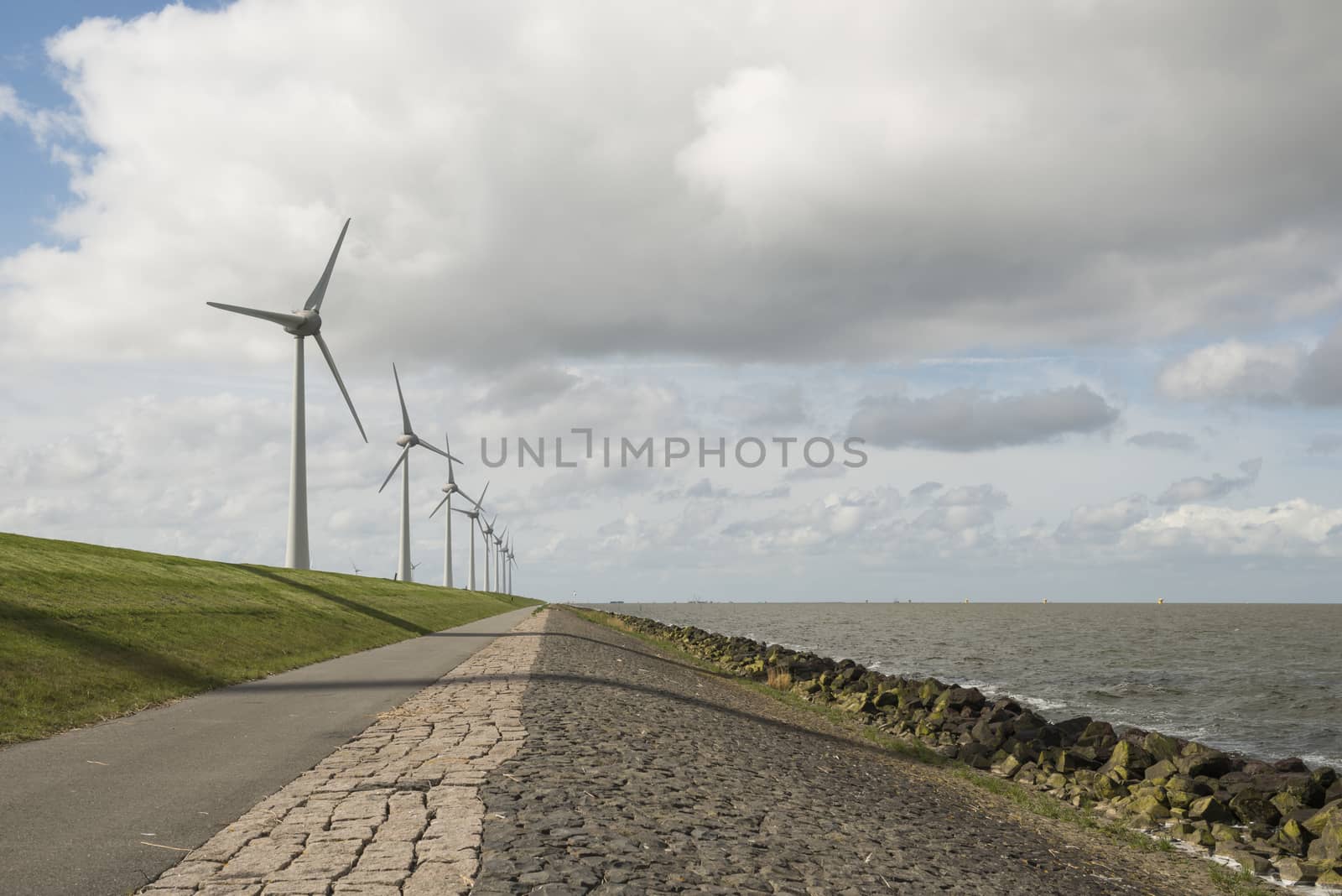 Modern windmills nearby the dike in the Netherlands by Tofotografie