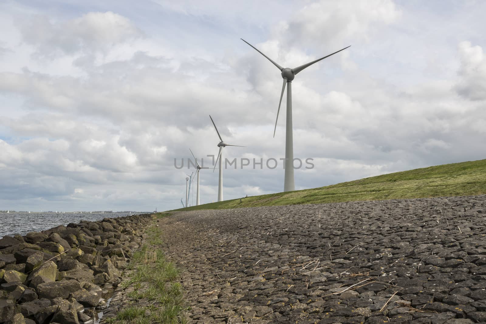 Modern windmills nearby the dike in the Netherlands by Tofotografie