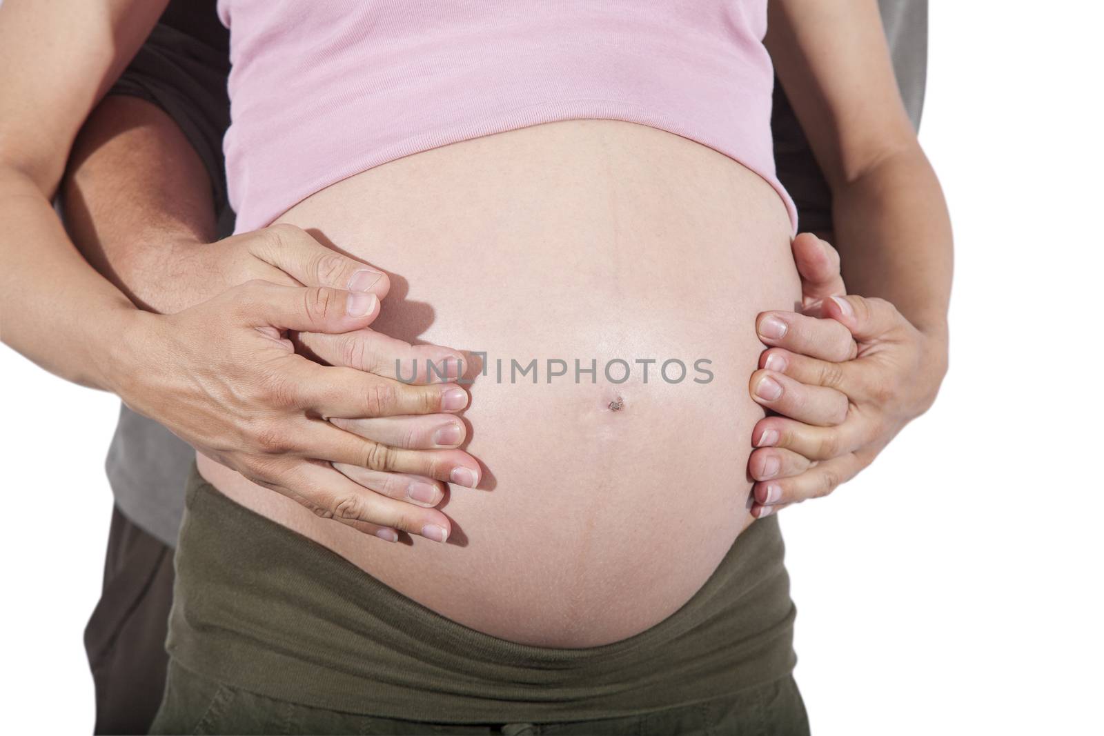 man and woman holding hands on front of naked paunch eight month pregnant isolated over white background