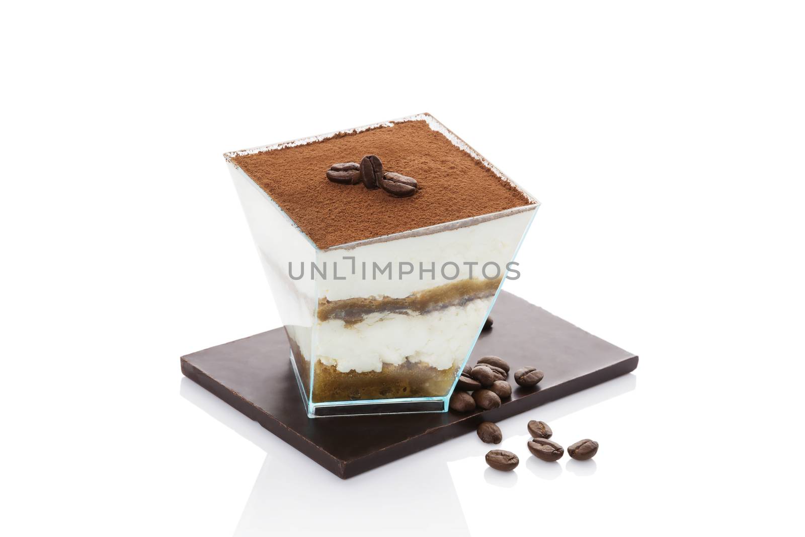 Tiramisu dessert on chocolate bar with roasted coffee beans isolated on white background. Italian sweet dessert concept.