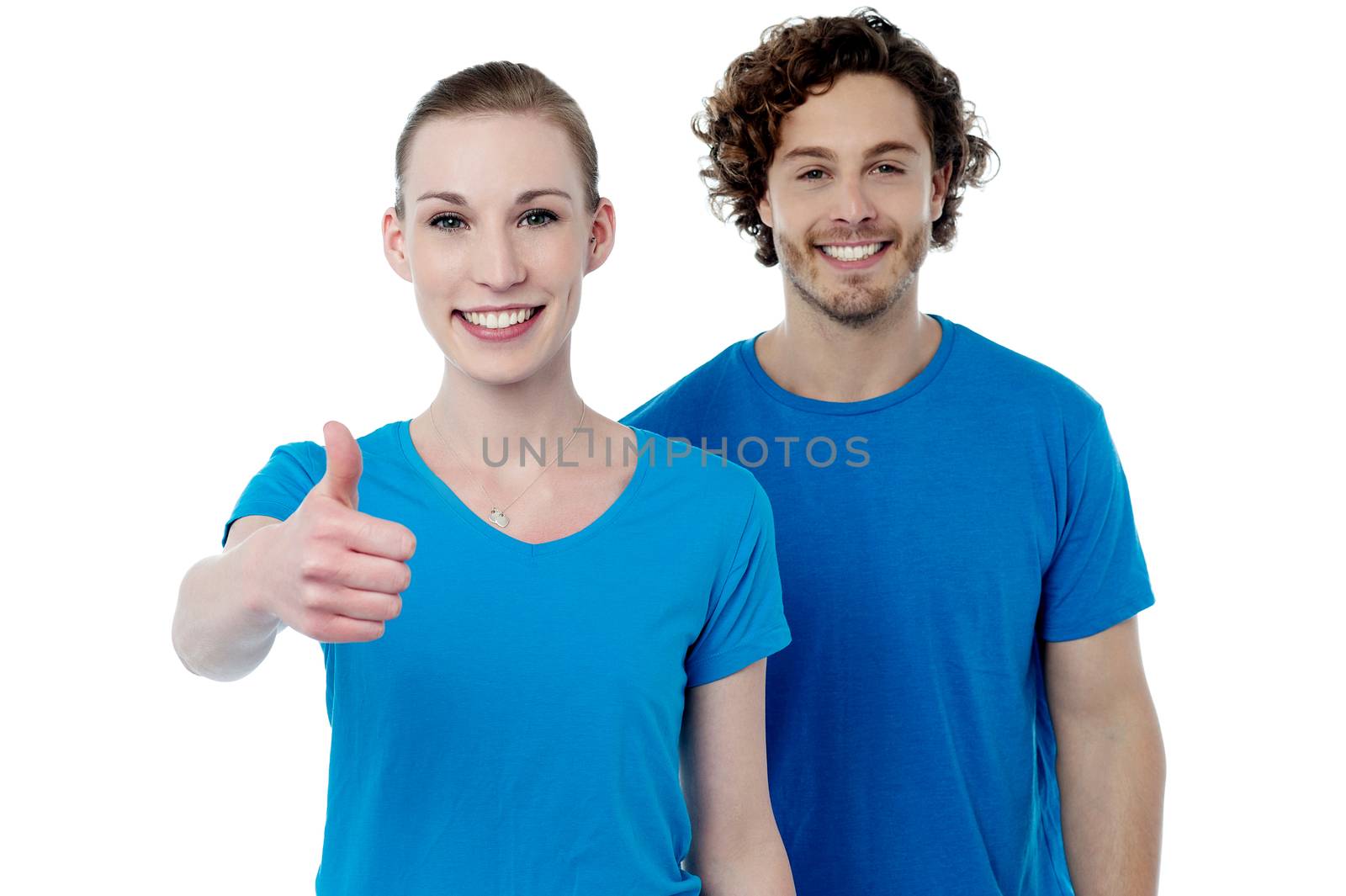 Happy woman gesturing thumbs up to camera