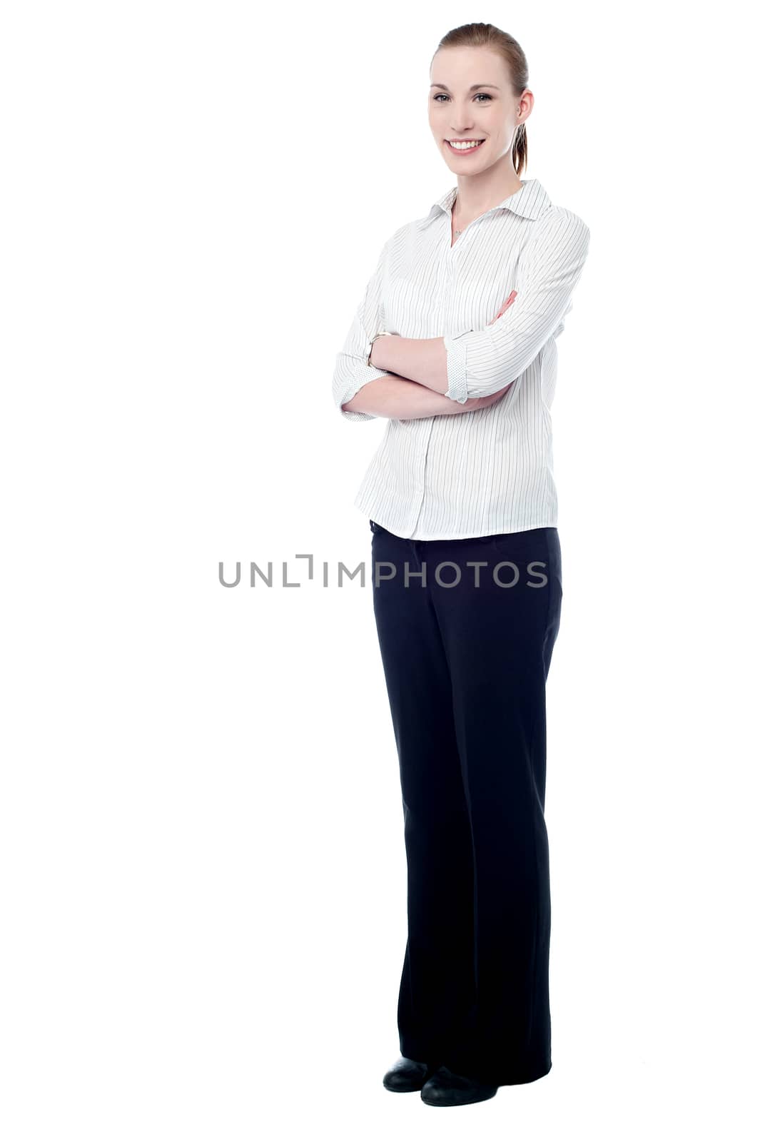 Full length of young business woman, folded arms.