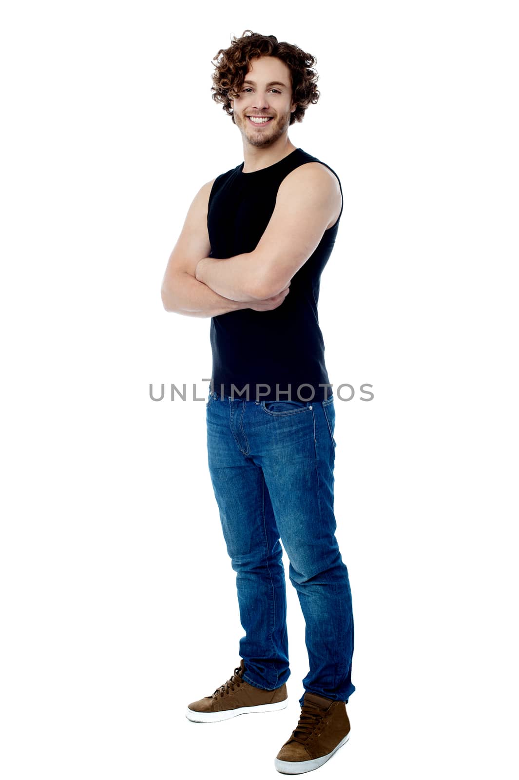 Handsome man posing with folded arms by stockyimages