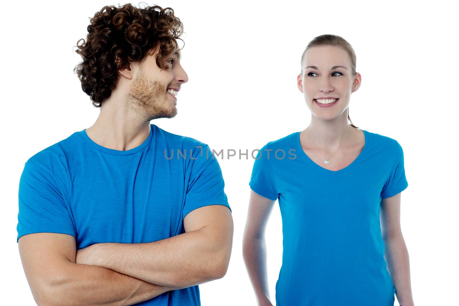 Happy young couple posing over white