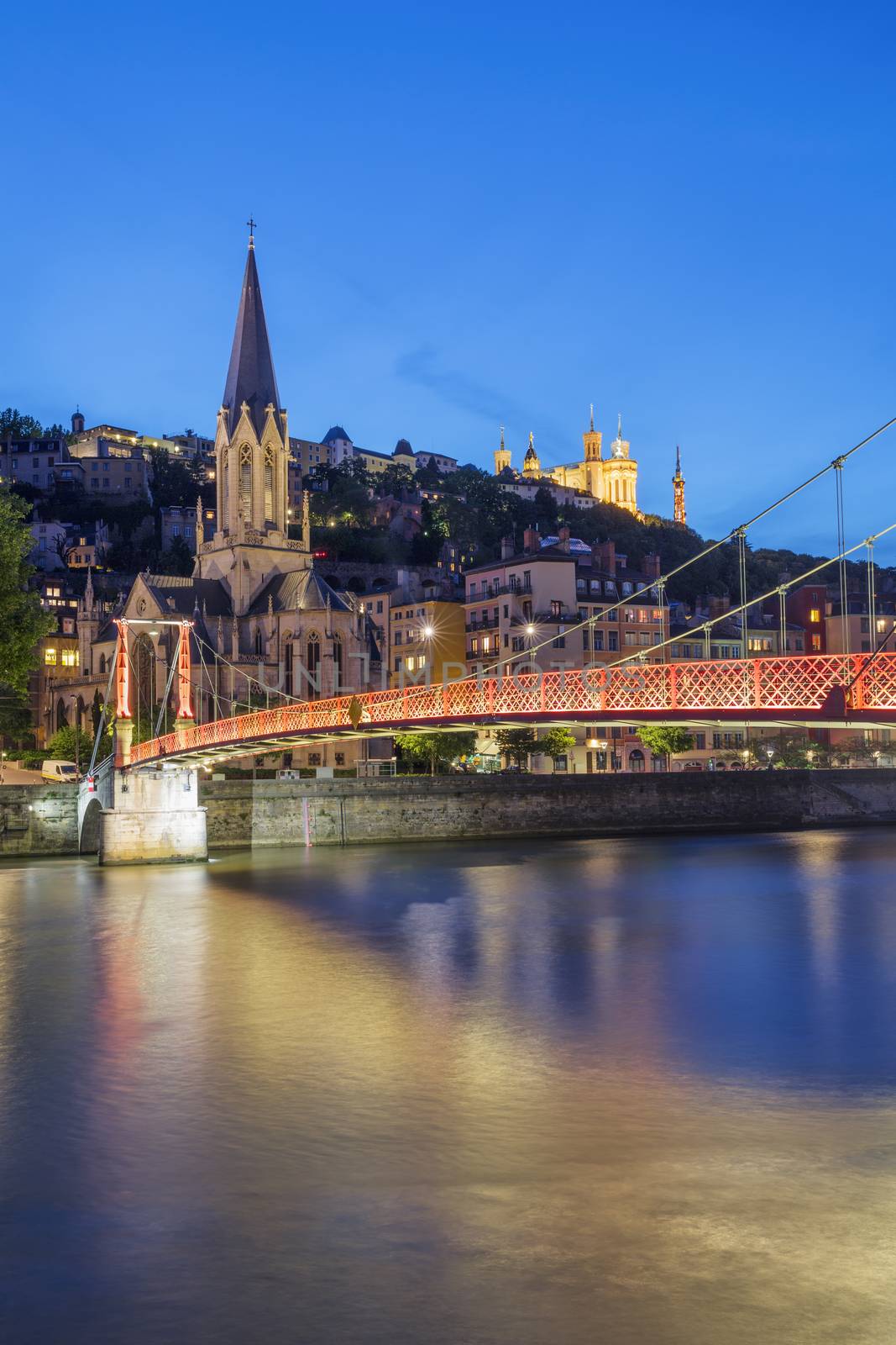 View of Lyon and red footbridge at night, France.