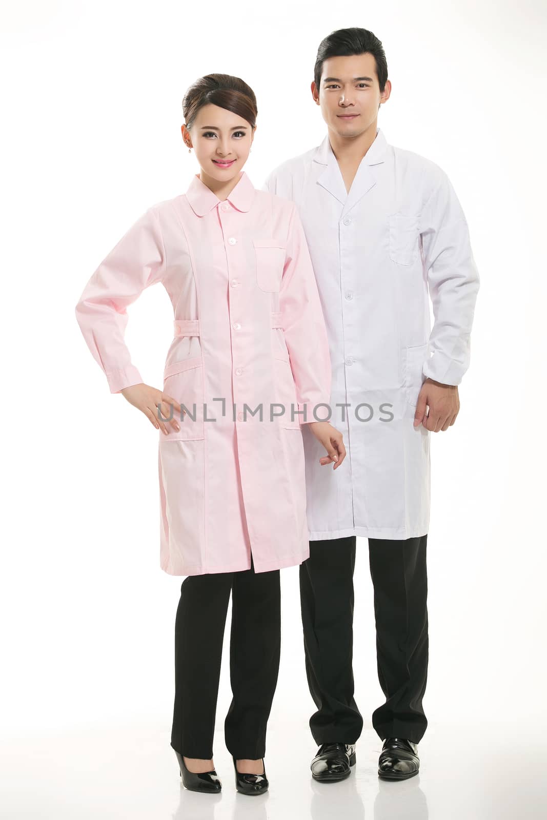 Staff wear coats in front of white background