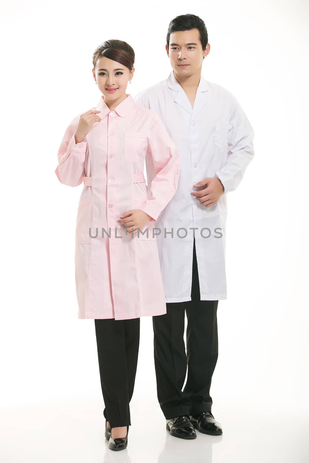 Staff wear coats in front of white background