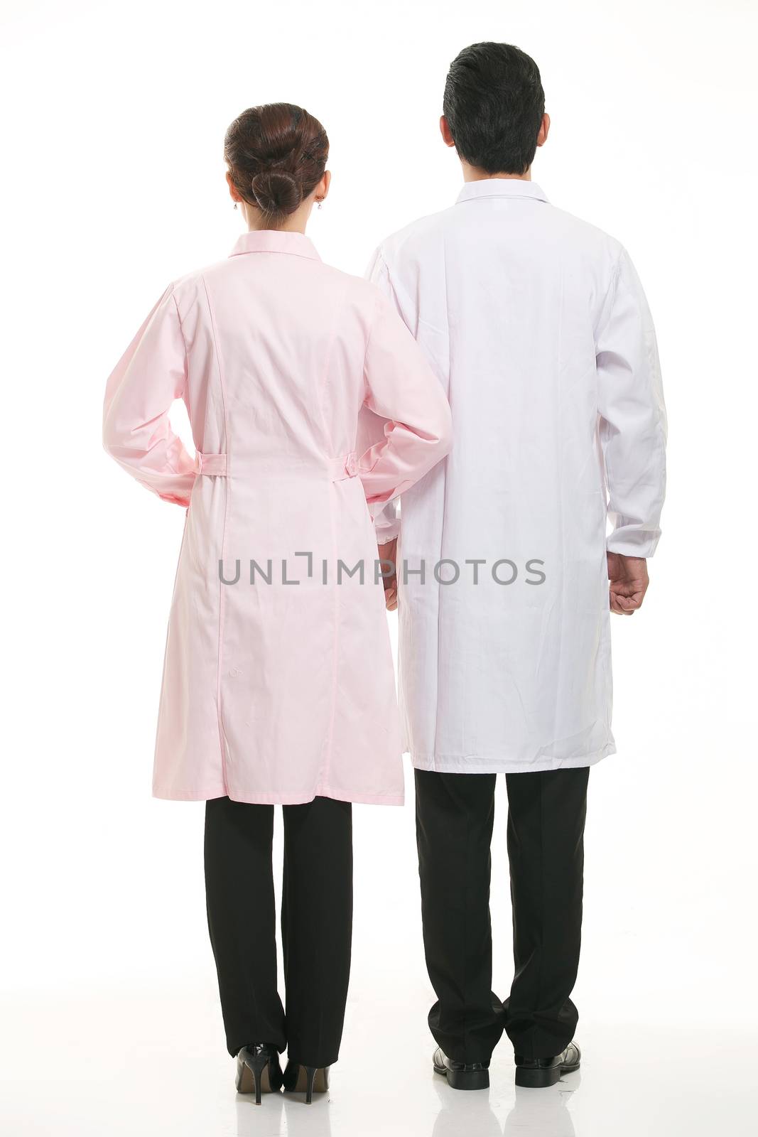 Staff wear coats in front of white background