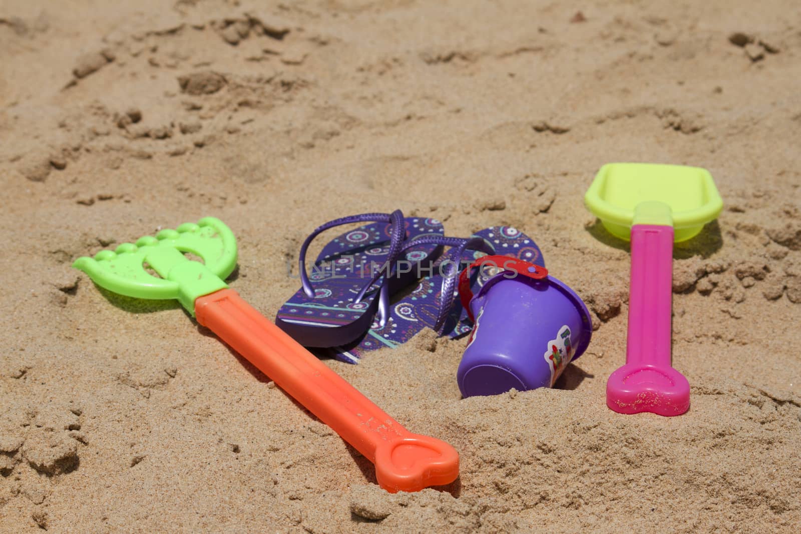 Children's colorful sandy toys on beautiful a beach. India Goa by mcherevan