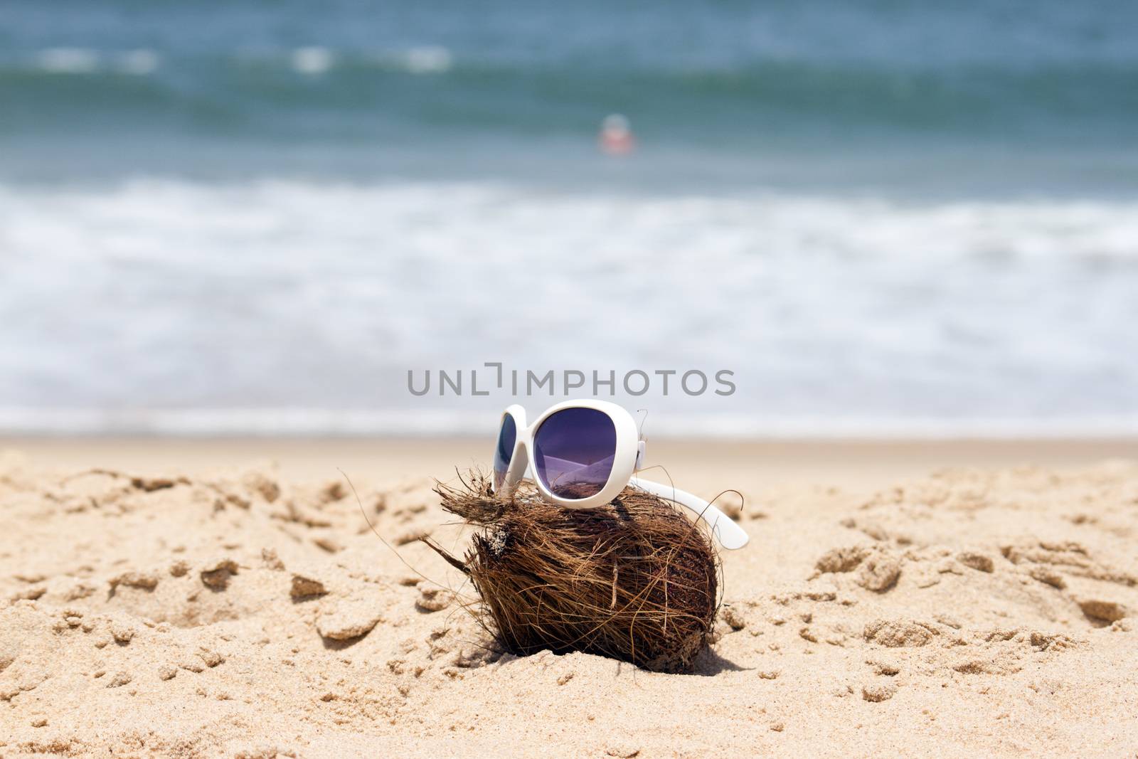 Coconut  and a sunglasses on a beautiful beach. India Goa by mcherevan