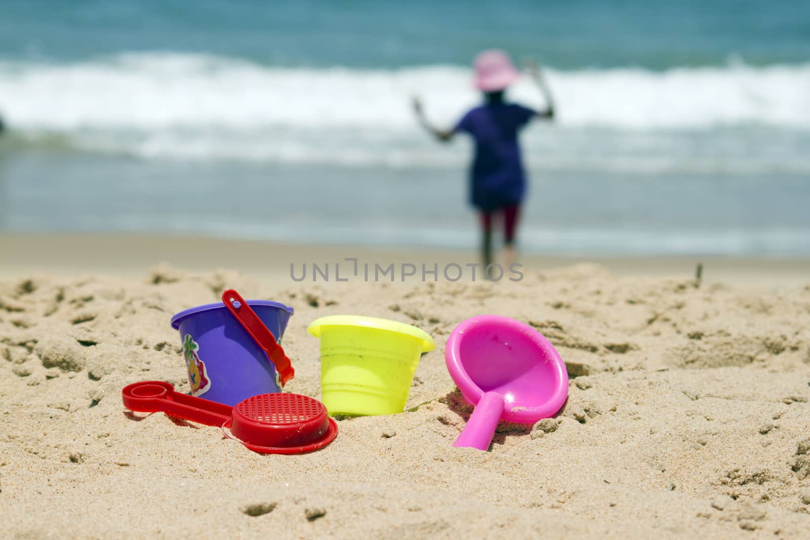 Children's colorful sandy toys on beautiful a beach. India Goa by mcherevan