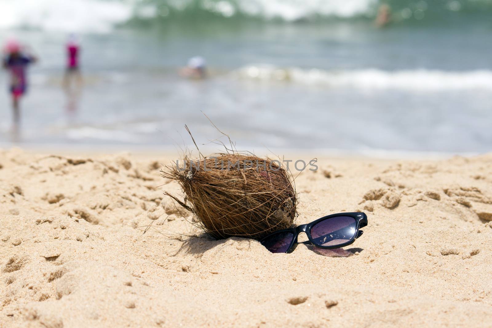 Coconut  and a sunglasses on a beautiful beach. India Goa by mcherevan