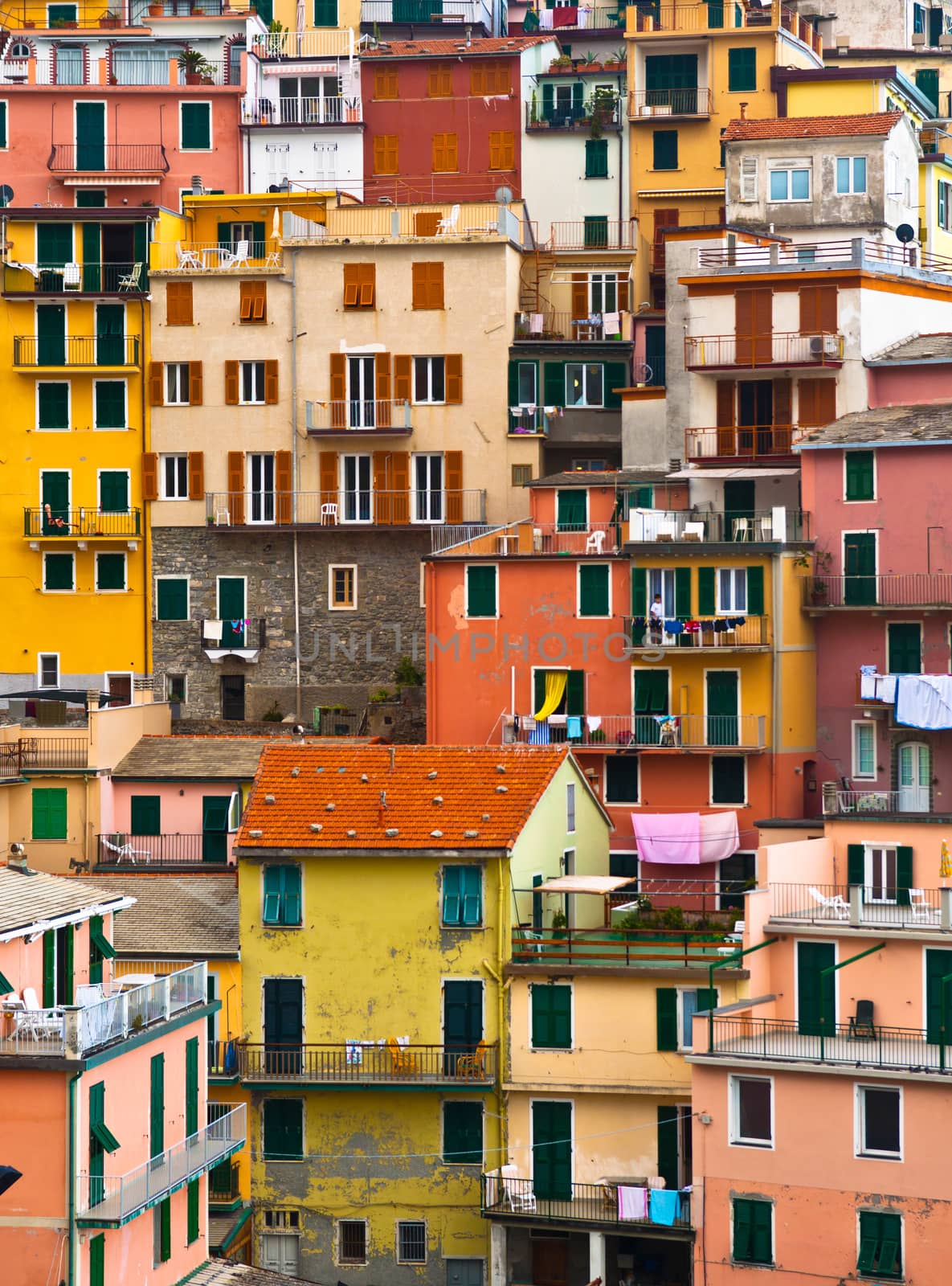 Colourful house frontings forming a beautiful background pattern. Manarola village, Cinque Terre, Italy. Vertical composition.