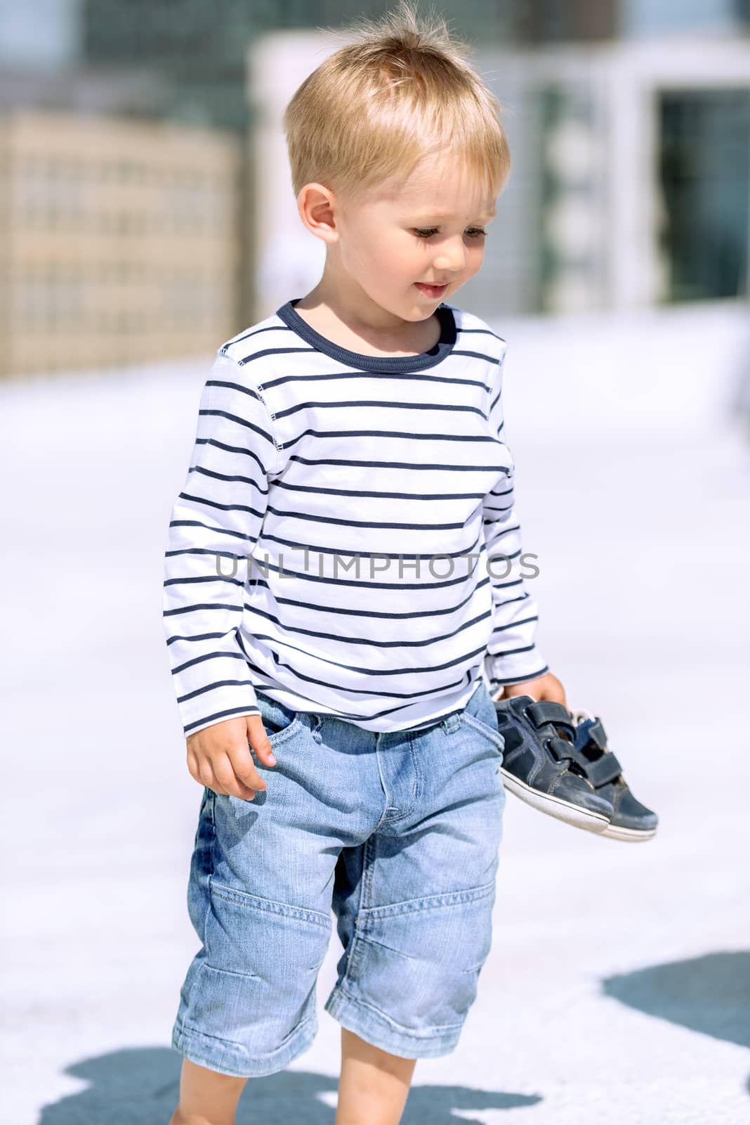 Portrait of little preschool boy outdoors.