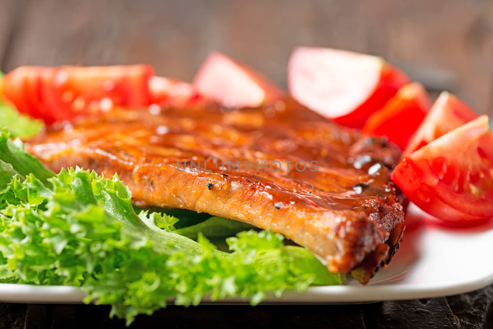 Delicious barbecued ribs seasoned with a spicy BBQ basting sauce by Nanisimova