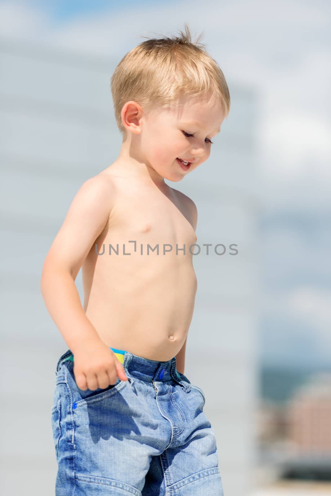 Portrait of little preschool boy outdoors smiling by Nanisimova