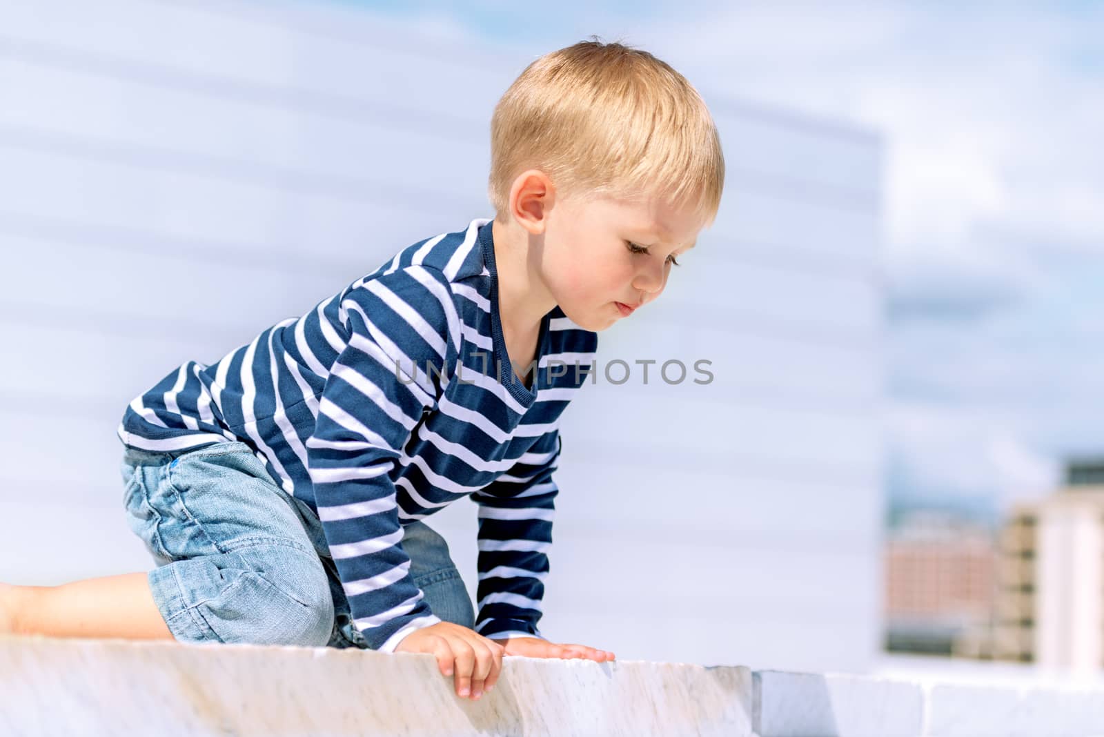 Portrait of little preschool boy outdoors not posing by Nanisimova