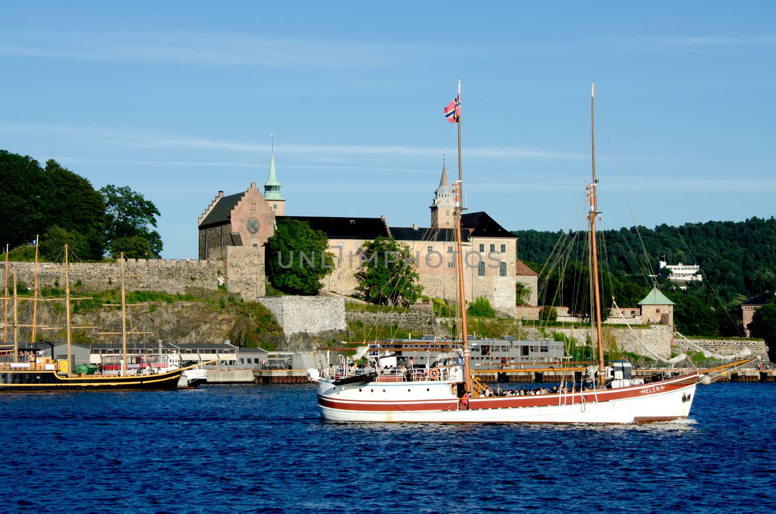 Old ship sailing in the Oslo fjord with Akershus fortress on background