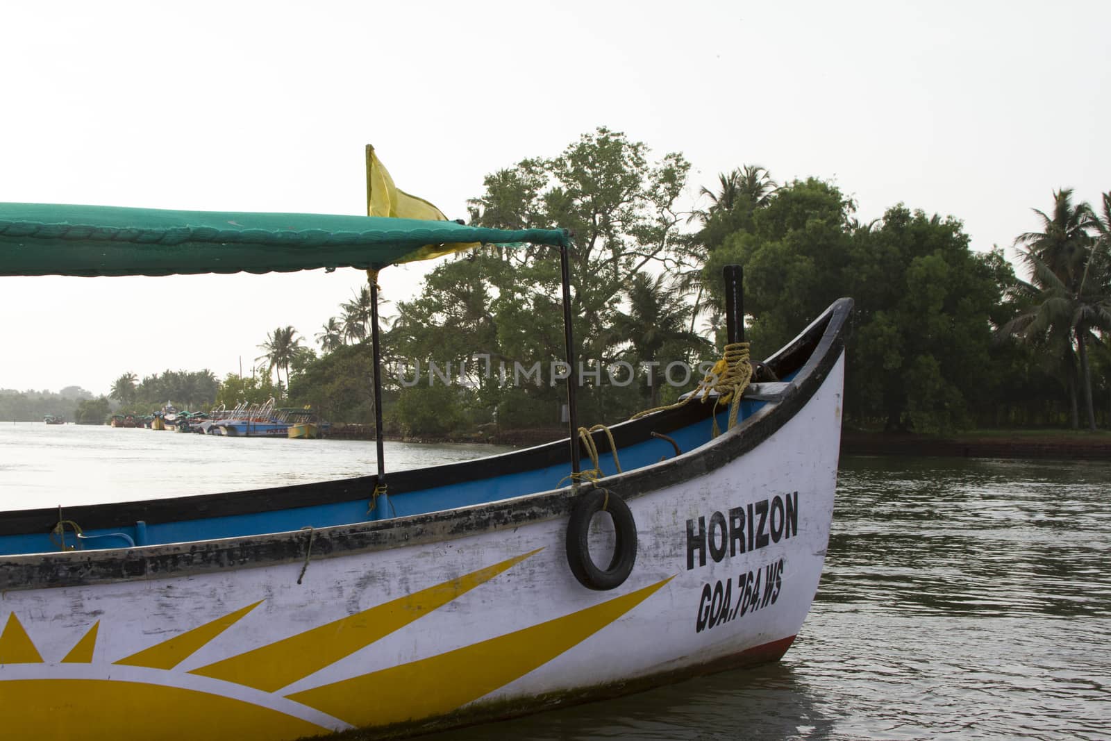 Old fishing boat standing on the sandy beach. India, Goa.