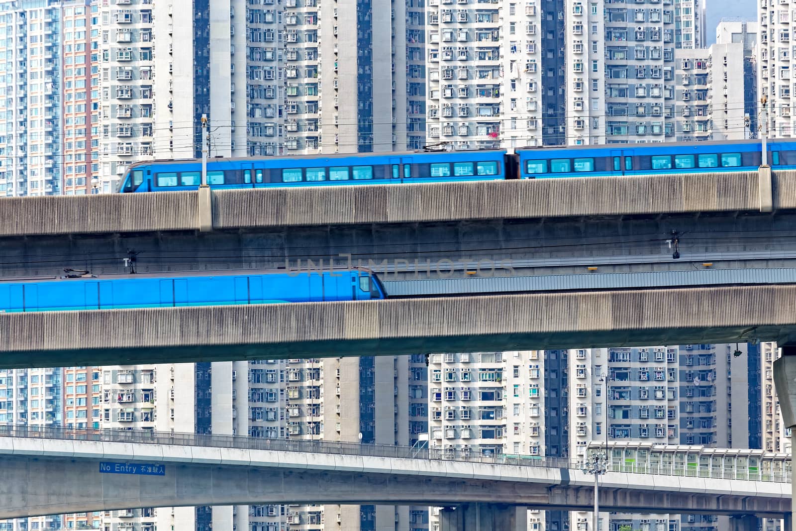 high speed train on bridge in hong kong downtown city at day