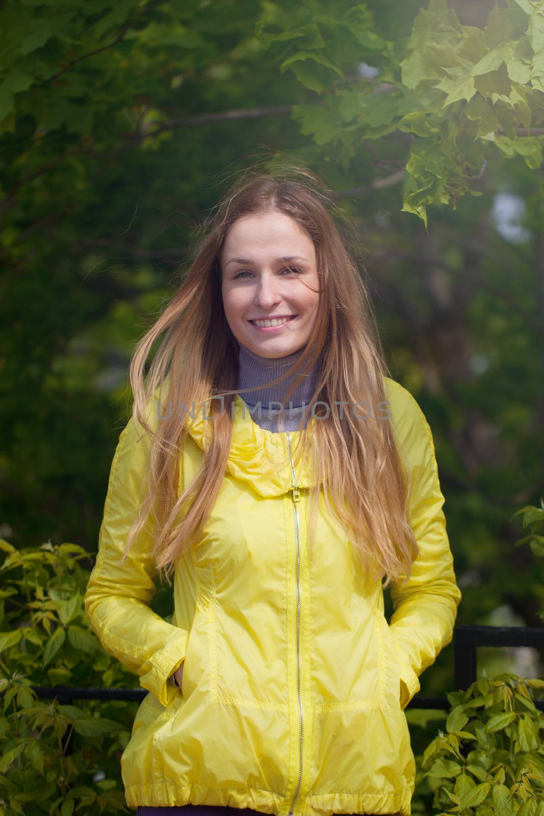 Portrait of beautiful smiling  girl against green park.