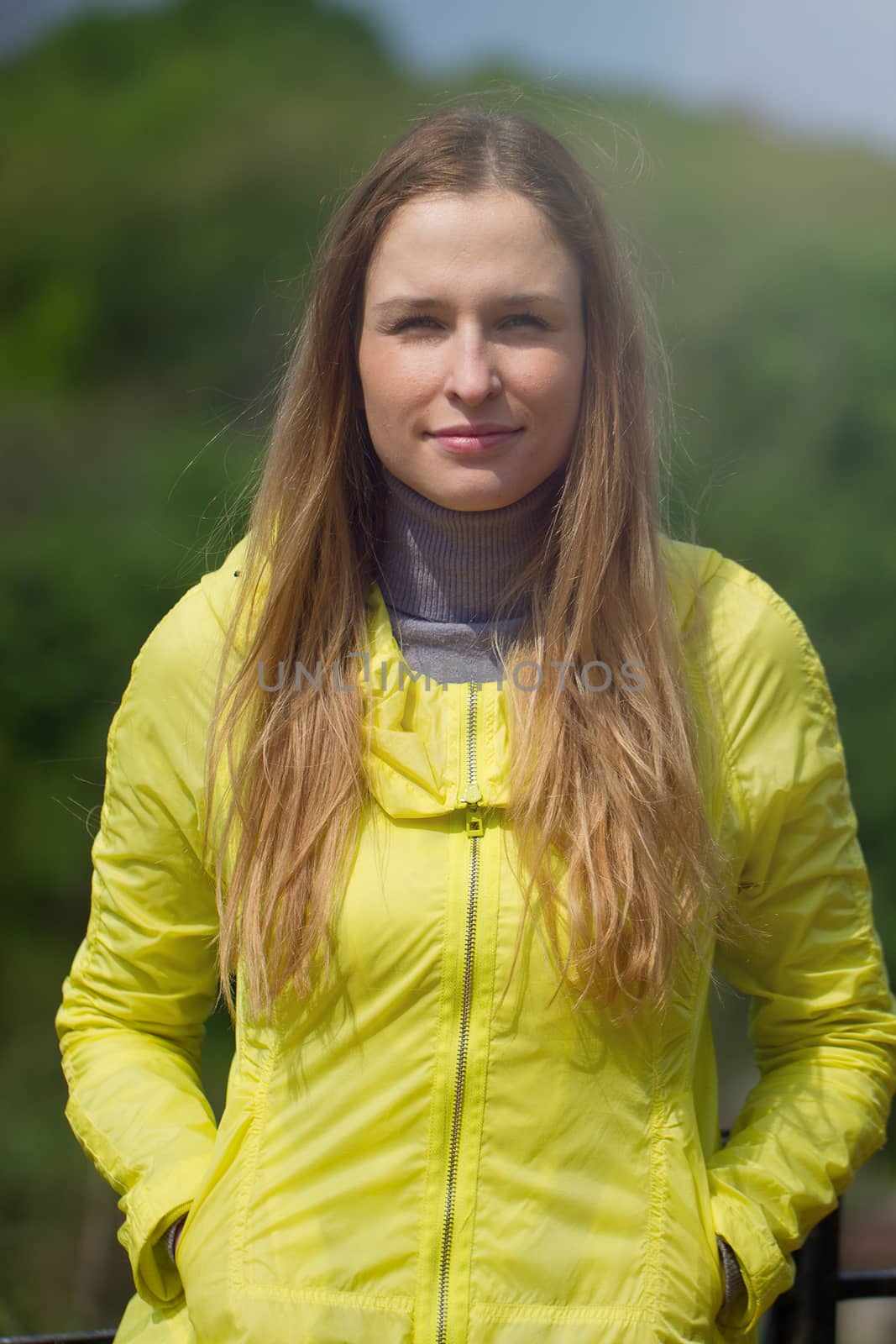 Portrait of beautiful smiling  girl against green park.