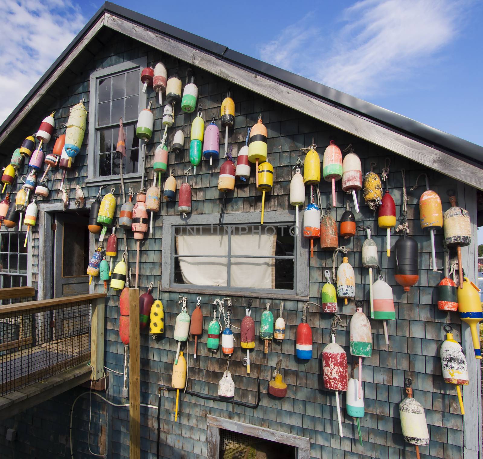 Maine lobster pound shack is decorated with old buoys, traps, and netting.