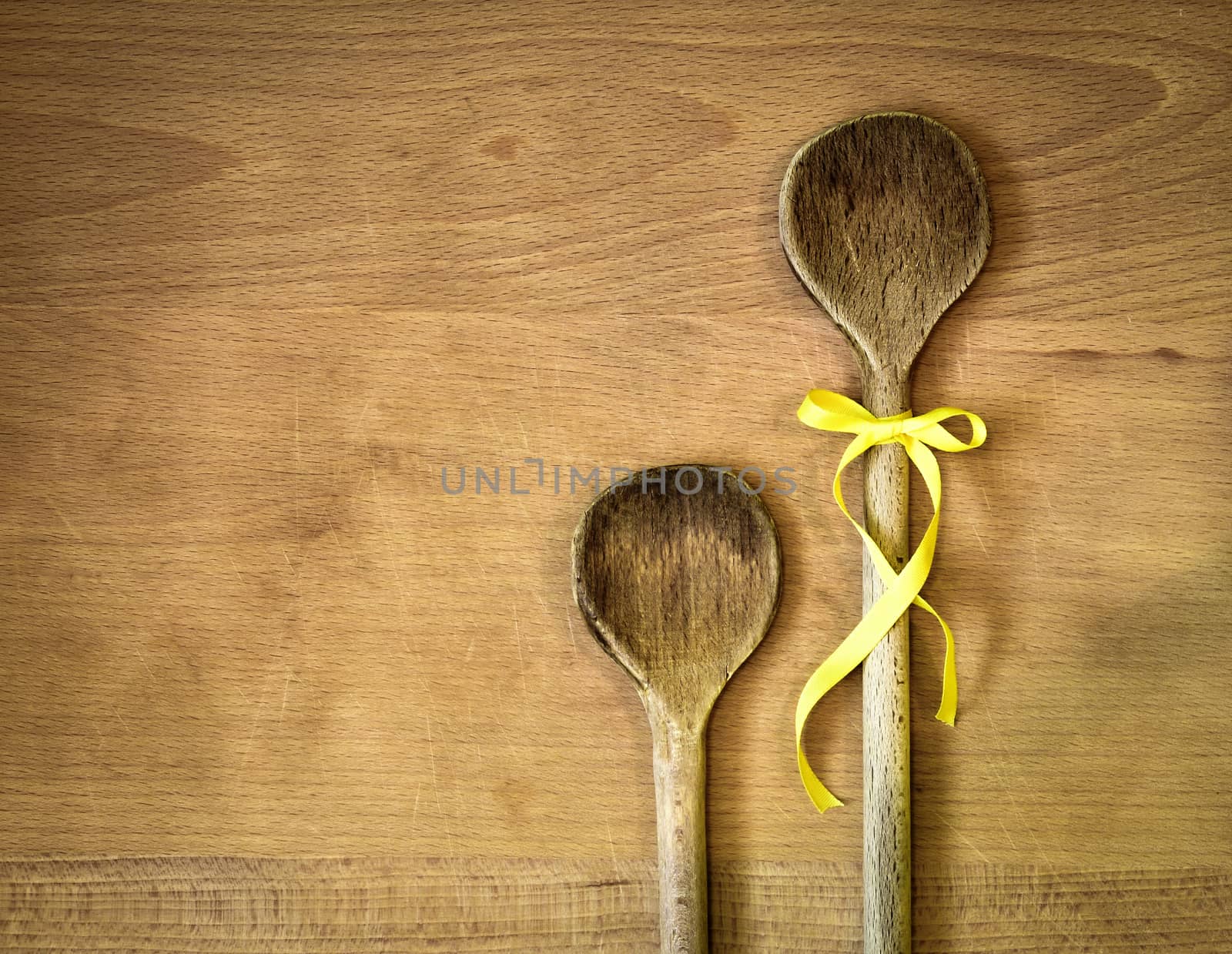 background two spoons with yellow ribbon bow