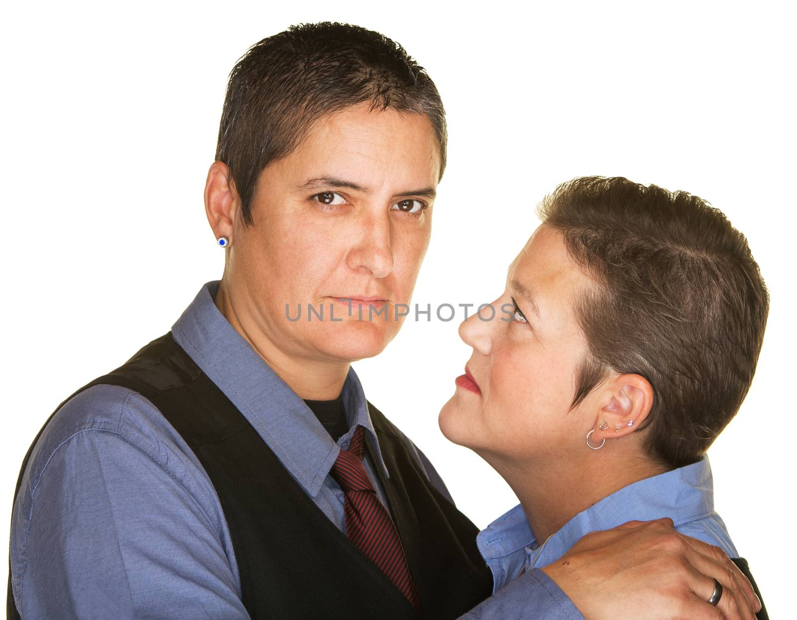 Serious gay couple holding each other over isolated background