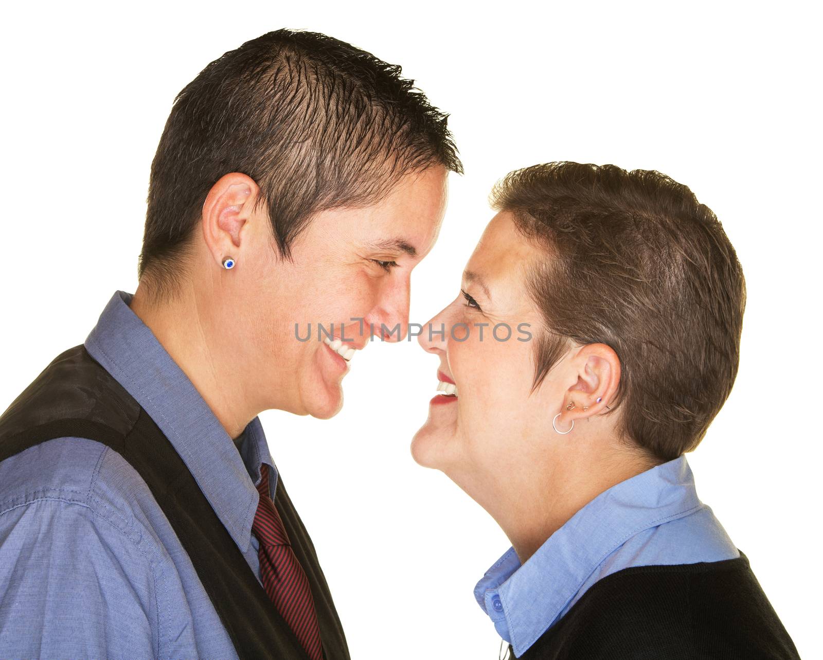 Laughing Caucasian lesbian couple facing each other