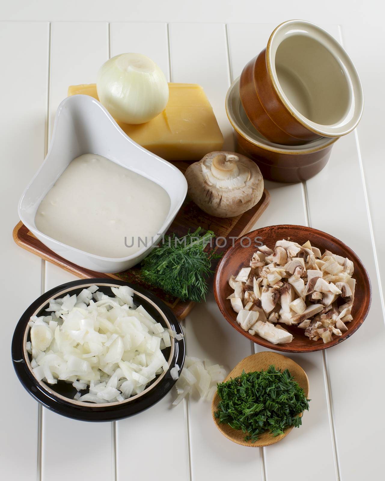 Ingredients of Mushroom Julienne with Raw Chopped Champignon Mushrooms, Onion and Dill with Bechamel and Cheese closeup on Plank White background