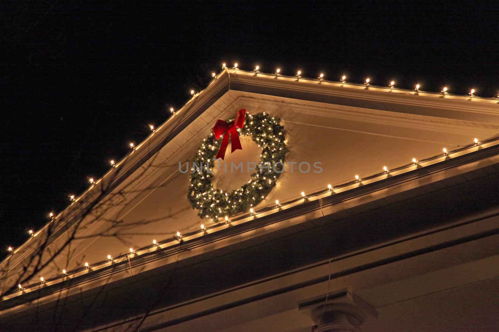 The top of a house with Christmas Lights