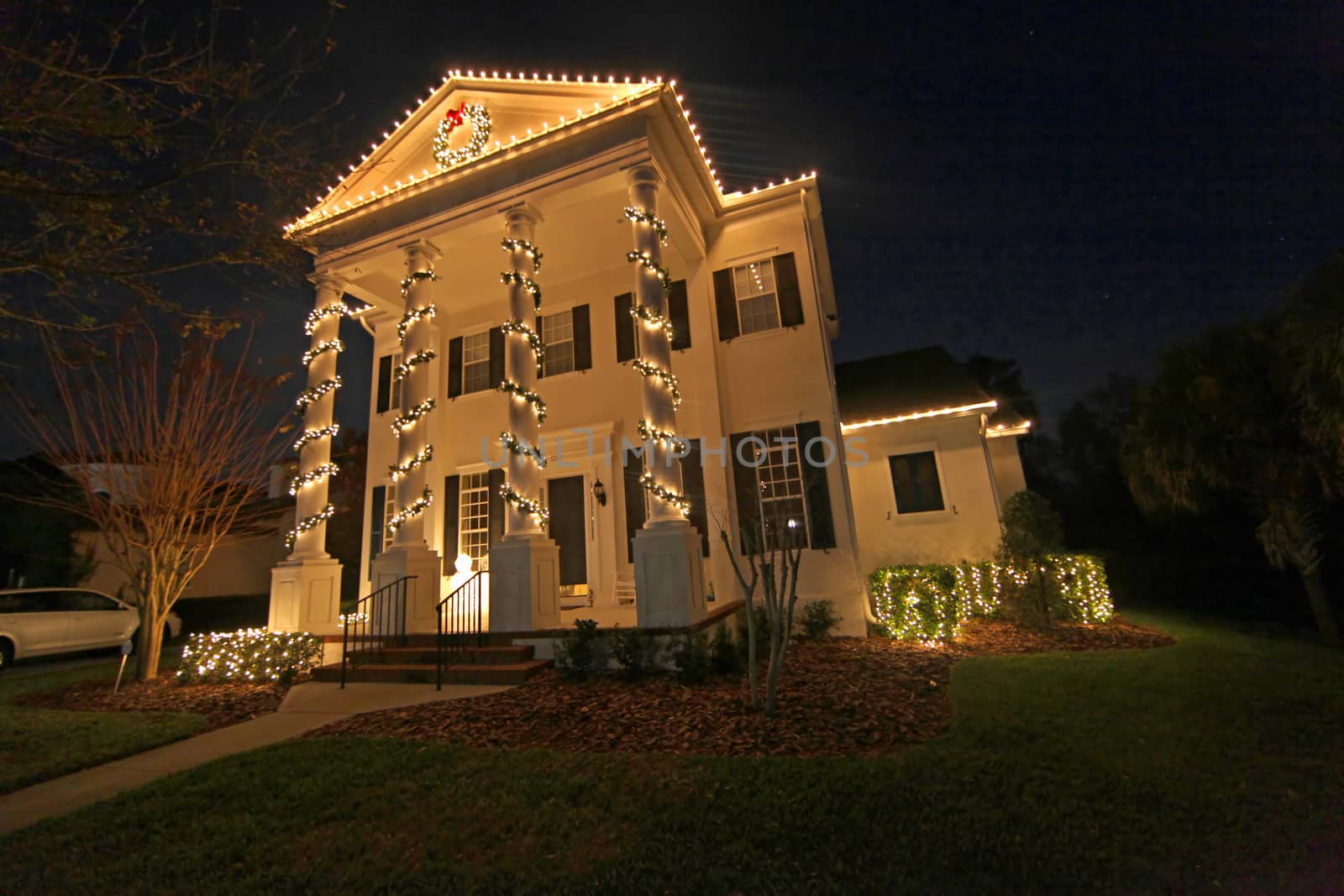 A Colonial House with a lot of Christmas Lights