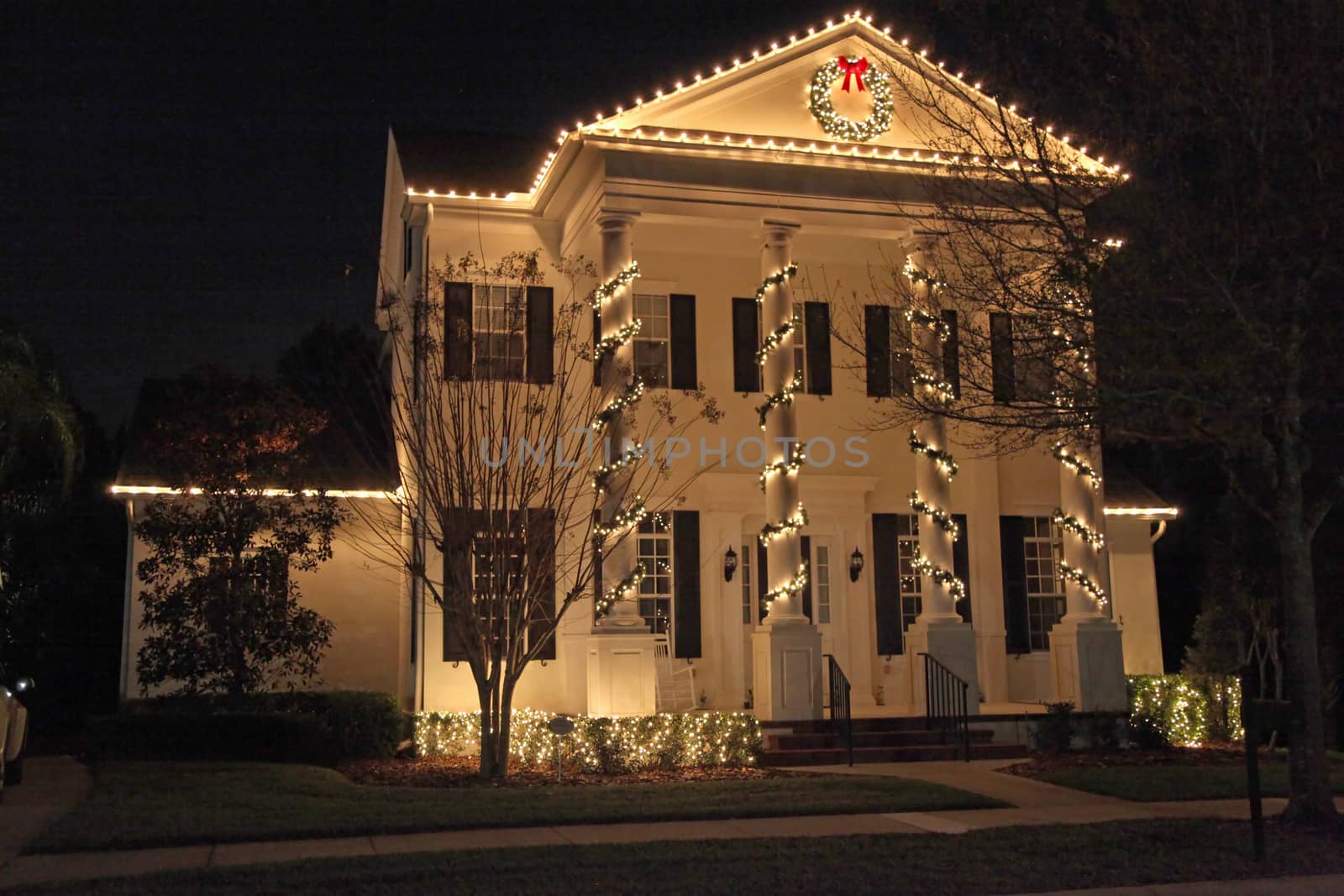 A Colonial House with a lot of Christmas Lights