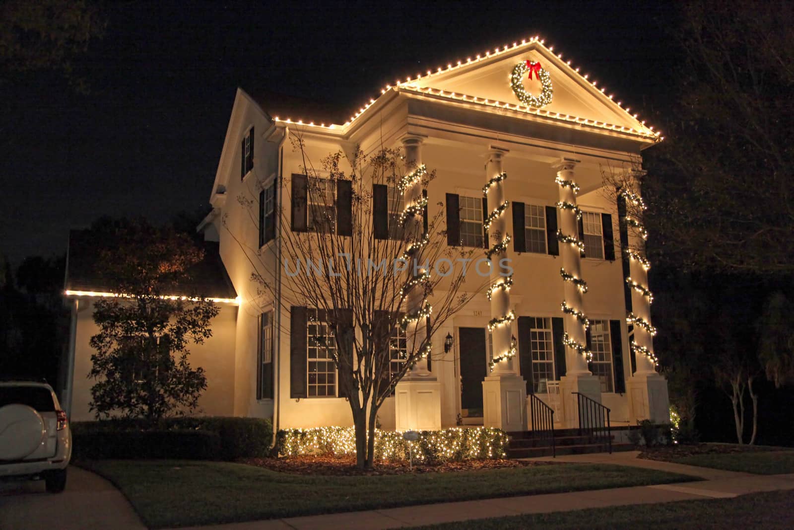 A Colonial House with a lot of Christmas Lights