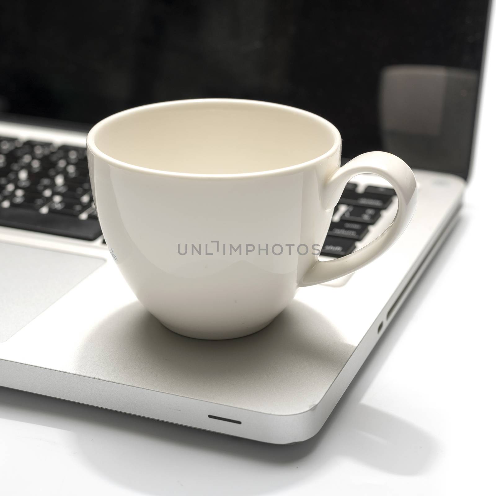 coffee cup on laptop isolated on white background