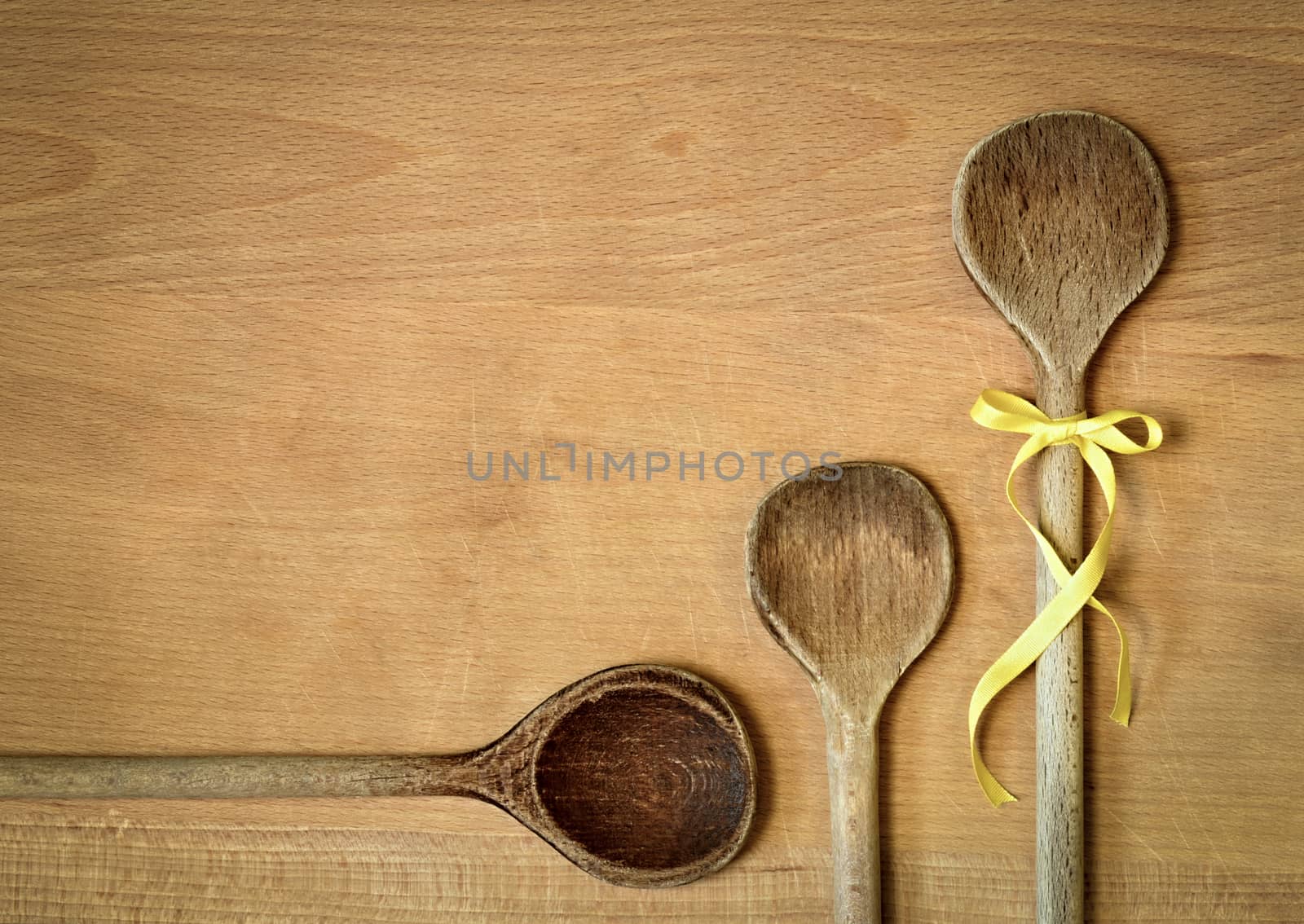 background three spoons with yellow ribbon bow