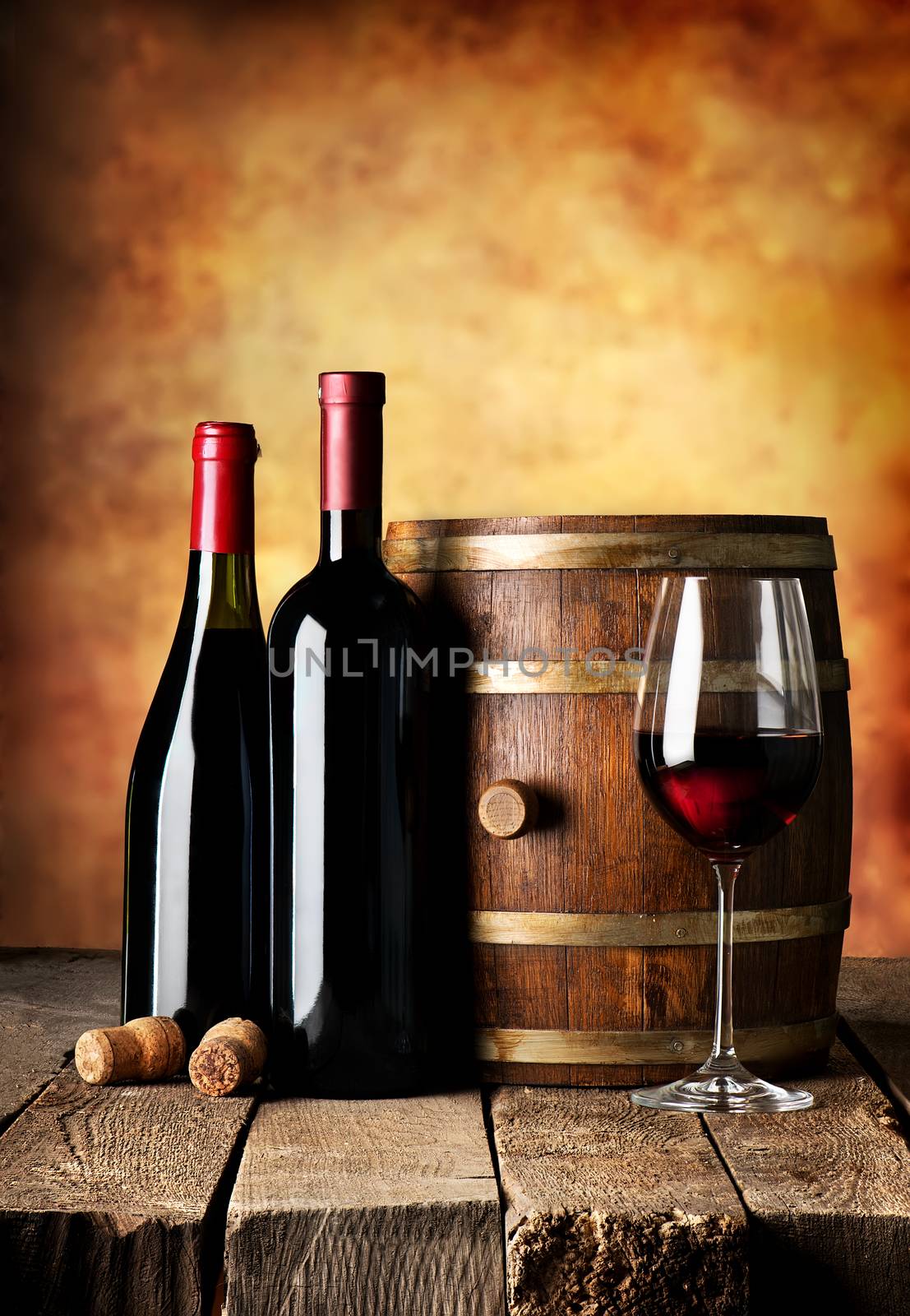 Bottles and cask of wine on a wooden table