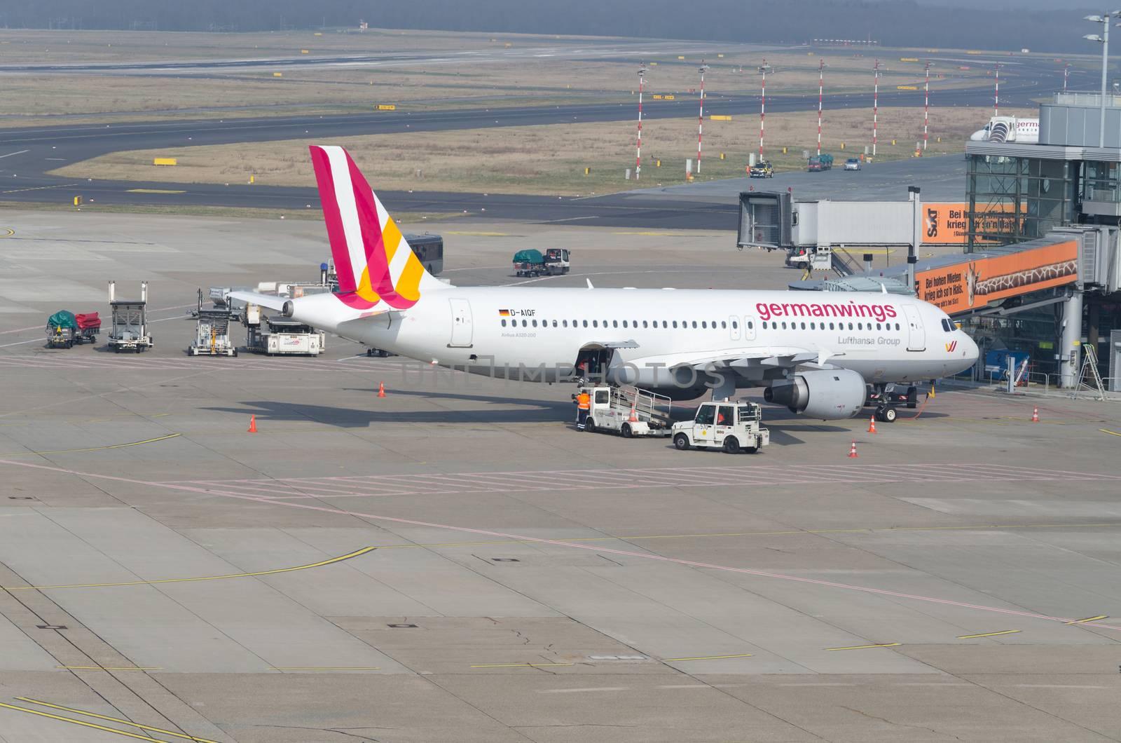 Dusseldorf, Nrw, Germany - March 18, 2015: German Wings Airbus A319 landing at the Dusseldorf airport. Terminal boarding passengers.
