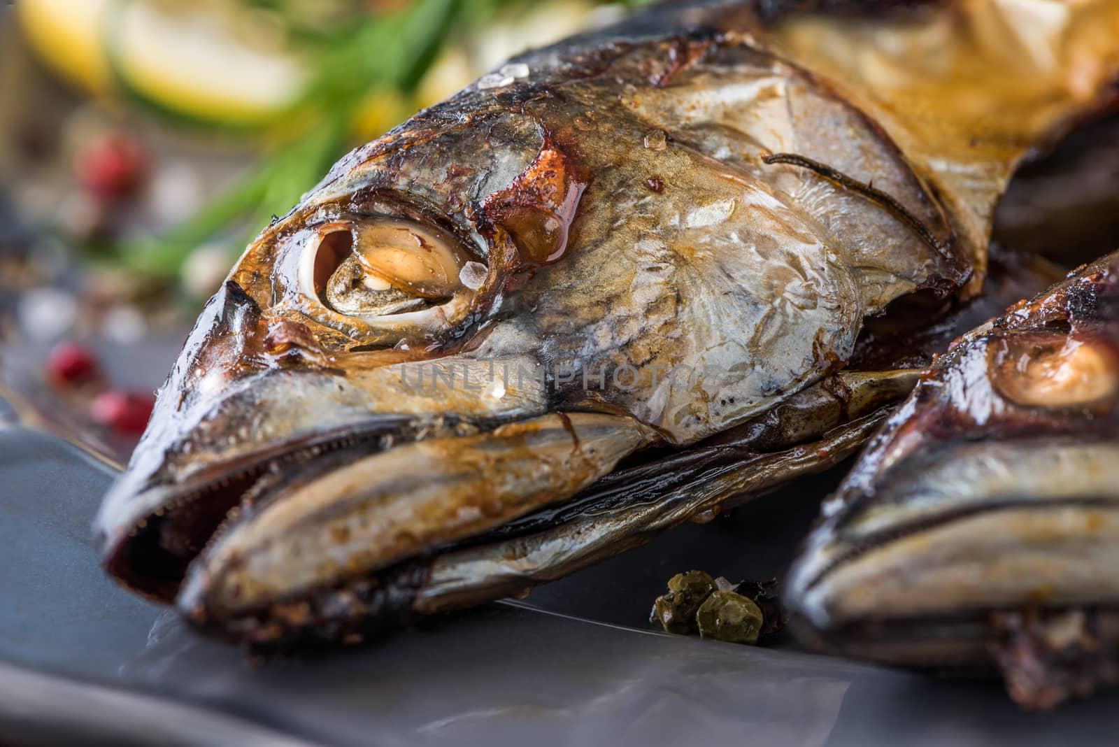 Baked Whole Mackerel Fish with Spice, Lemon and Rosemary on a Plate on Wooden Table