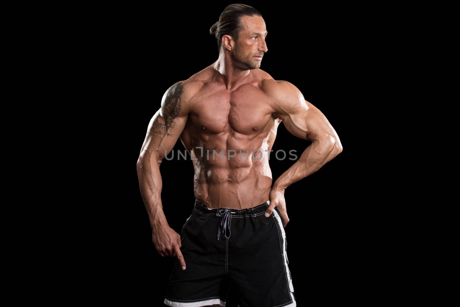 Muscular Bodybuilder Man Posing Over Black Background by JalePhoto